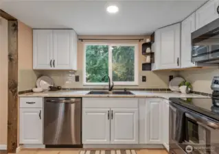 Upgraded kitchen with granite counters, upgraded appliances and new flooring. All appliances stay with the home.