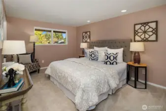 The primary suite overlooks the backyard and includes an attached bath and walk-in closet; all four bedrooms are located together on the upper level. Hardwood floors are located beneath the new (2025) carpet throughout the upper level.