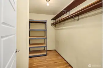 Large (5 feet by 9 feet) upper-level storage closet with a chute to the laundry room. Those are the hardwood floors that are beneath the new (2025) carpet.