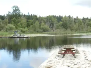 View of end of dock showing neighbor's dock and east side of lake.