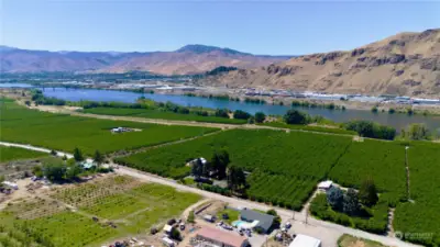 From over the ranch house here is view looking down Columbia to Odabashian bridge and Wenatchee proper.  This orchard has many shares of water from the Columbia River and two wells for ample water to serve this property!!!!!!  View looking W/SW