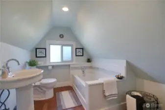 Bathroom upstairs offers a large tub.
