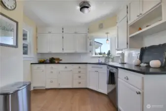 Nice, bright Kitchen w/solid surface counters & wood floors.