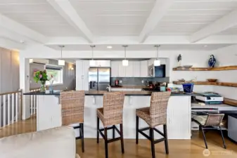 There is a  lovely eating bar where guests can sit and visit while the cook is prepping a meal. A desk to the right is the perfect place to keep yourself organized.