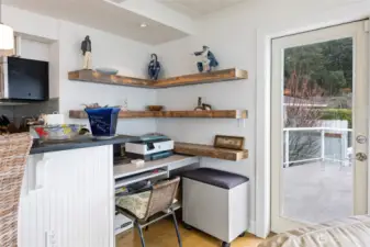 A mini office is a part of this home and is a great space to stay neat and organized. The door to the right leads out to an expansive deck for easy outdoor entertaining/barbecuing.