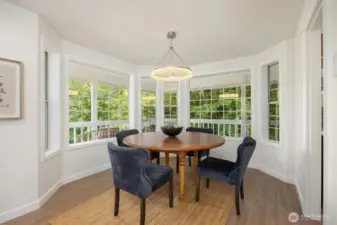 Enjoy this cozy dining room surrounded by windows with easy service from the adjacent kitchen