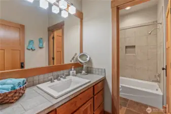 Full main bath with comfort height cabinetry & tiled in tub surround....