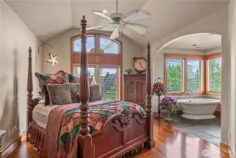 Arched details continue on the second floor in this grand suite! Soaking tub with a view!