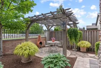 Gazebo area sits behind outdoor kitchen & fireplace...