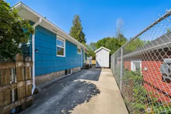 There is a gate that swings shut and latches if you wanted your car behind the gate creating a fully fenced yard.