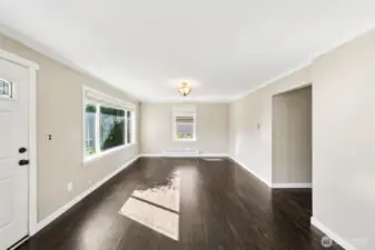 So much natural light in this living room! Take a look at those original hardwood floors.