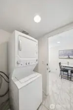 Take the stairs down to the deluxe suite. The laundry room is in the stairwell connecting the upstairs and the basement.