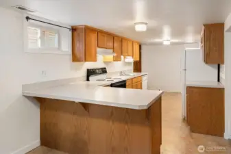 The apartment kitchen has plenty of counterspace to prep.