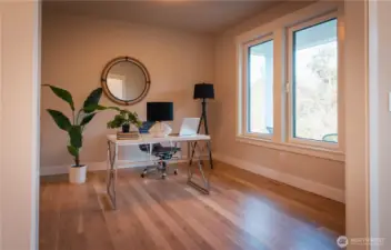 This versatile flex space offers the perfect blend of function and comfort, ideal for today’s dynamic lifestyle. Bathed in natural light from a large window, the room feels bright and inviting, highlighting the warm wood flooring and clean, neutral palette. Currently set up as a combination home office, it easily adapts to your needs—whether you envision a productive workspace, workout room, hobby studio, or even a formal living or dining area. Thoughtfully arranged with ample open floor space, this room showcases just how effortlessly it can support multiple uses while maintaining a sense of calm and organization.