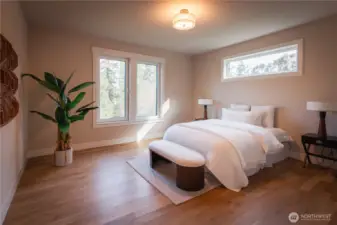 The primary suite offers a peaceful retreat with ample space and soft natural light. Clean lines and a neutral palette create a calm, relaxing environment, while the layout allows for comfortable furniture placement and easy flow.