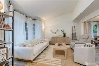 Formal living room features big windows and vaulted ceiling