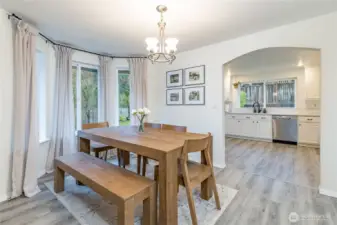 Bright dining room with arched doorway to the kitchen