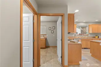 Coming from garage (L) utility room. Straight is laundry and 1/2 bath