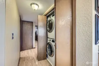 Stacked washer and dryer tucked away next to the kitchen for convenience.