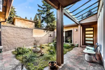 Interior Courtyard with covered walkway to the front door.  Office/gym is behind the sliding door to the left
