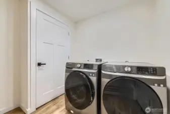 Laundry room just off the kitchen. Water heater location beyond the door