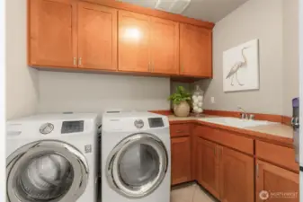 Laundry with folding spaces and storage.