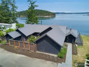 The main house features an inner courtyard and is nestled along the shore.