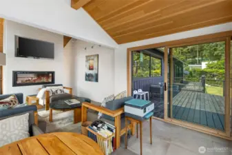 The sunroom also features a propane fireplace and a sliding door to the deck.