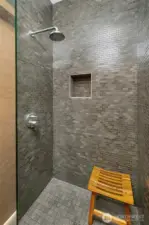 The shower room next to the powder room off the hallway.