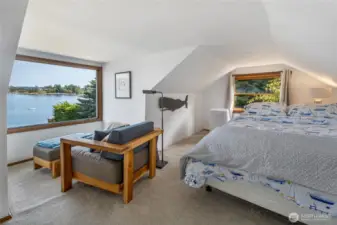 The bedroom on the upper level of the farmhouse features a picture windows to take in the spectacular view. There is a second bathroom on the upper level and a separate entrance as well.