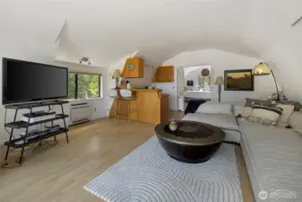 The apartment above the shop, looking from the entrance to the living room, kitchen and bedroom beyond.