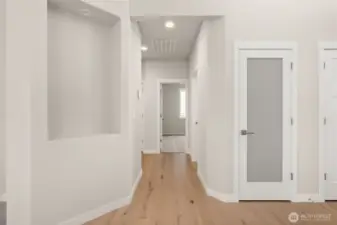 Decorative wall niche and pantry closet with solid shelving and frosted glass door for easy access from kitchen.
