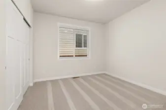 Adjacent to full bathroom is the second bedroom featuring a large reach-in closet.