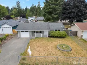 Fully fenced yard wraps the property.