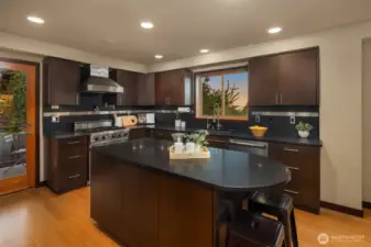 Chef's kitchen to awaken the culinary senses. Subzero Refrigerator, black granite countertops, built-in Sharp Microwave, Viking Gas Range, Jenn-Air Dishwasher, Pantry with Custom Built-ins and Wine Refrigerator.