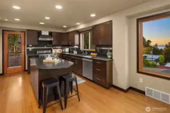 Kitchen offers the best of both worlds! Views of the Sound and Olympic Mountains. Seating for guests around the granite bar. Delve into good conversations.