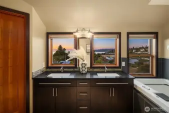 Primary bathroom offers spa steam shower with 8 sprayer heads, jetted smart tub with lights and heated flooring with views of the Sound and Mountains.