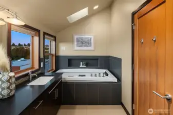 Jetted smart tub with lights and heated tile flooring.