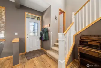 Once inside, you will see the entry with stairs leading to the half bath, bedrooms, and laundry.