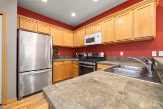 The kitchen is spacious with a lot of counter and cabinet space.