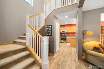 From the entry there is the stairway to the beds, baths and laundry with the kitchen beyond.