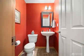 There is a half bath at the stair landing just off the front entry.