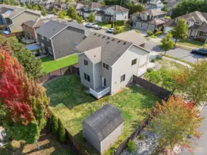 An aerial view from the back of the property showing the full fenced back yard with 10x12' shed.