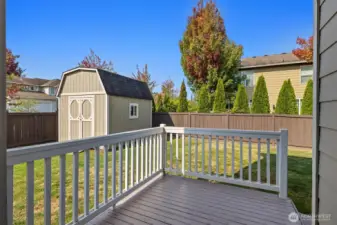 The deck off of the kitchen leading to the spacious well cared for and fully fenced back yard