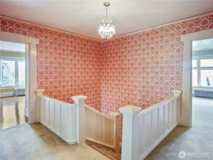Walk up the stairs to four large bedrooms, a sunroom, and two bathrooms.