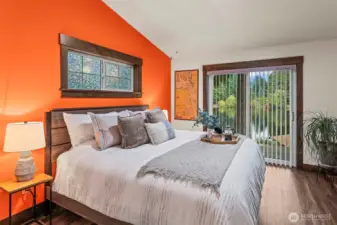 The warm and inviting primary sweet has its own sliding doors to the deck.