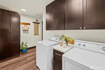 Laundry / Mud room with a pantry style closet and door to the outside path from the garage