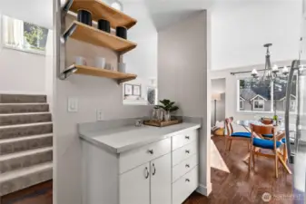 The kitchen also has a lovely pass-through, to greet folks as they come up the stairs, with additional open shelving storage.