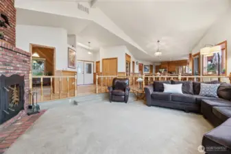 Spacious living room with cozy wood-burning fireplace.