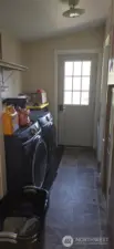 Side entrance into laundry room. Also has door into primary bathroom.